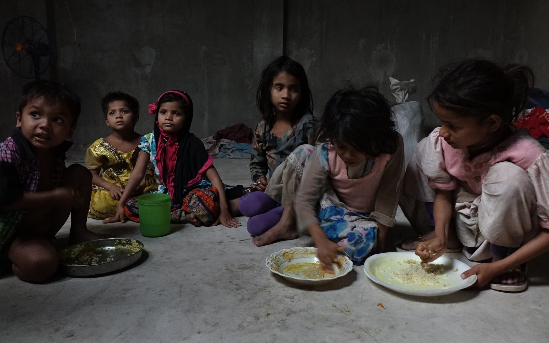 Some Rohingya children are taking their meals inside a makeshift Rohingya refugee camp at an unidentified location in eastern Indian state of West Bengal. Most Rohingya refugees work as rag-pickers in India and live in marginalised society. CREDIT: SHAIKH AZIZUR RAHMAN