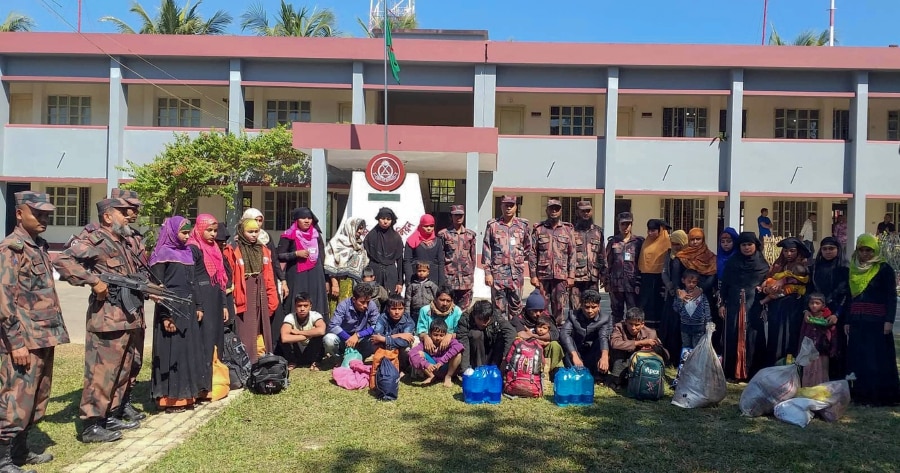 Rescued Rohingya refugees pose for photographs at the Border Guard Bangladesh camp in Teknaf on Feb 8, 2019. Bangladeshi border guards have rescued 30 Rohingya refugees from a coastal town who were waiting to board on boats which would "take them to Malaysia", an official said on Feb 8. (Photo by STR / AFP)