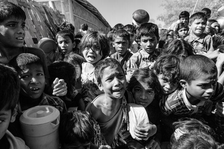Rohingya refugee children cry and struggle in the crowd as they wait to receive food outside a distribution point of the Turkish aid organization TIKA at the Jamtoli refugee camp near Cox's Bazar, Bangladesh, December 01, 2017. (Photo by Szymon Barylski/NurPhoto via Getty Images)