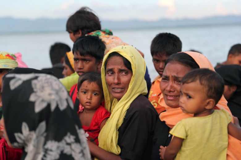 Rohingya refugee women cry while crossing the Naf River with an improvised raft to reach to Bangladesh in Teknaf, Bangladesh, Nov 12, 2017.