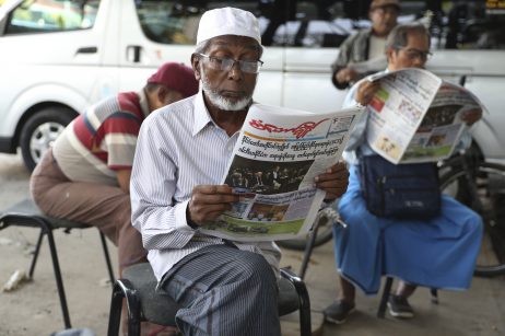 People read newspapers with front pages leading with Myanmar leader Aung San Suu Kyi at the International Court of Justice hearing near a roadside journal shop, Dec. 12, 2019, in Yangon, Myanmar. Credit: AP Photo/Thein Zaw