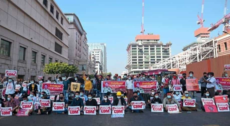 Demonstrators hold signs during a protest against the military coup in Yangon, Myanmar, February 17, 2021 Photo: Reuters