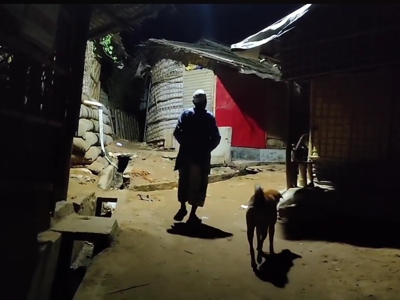 A old Rohingya man waking up observants for pre-dawn meal in the Cox's Bazar refugee camp. Photo by Sahat Zia Hero.