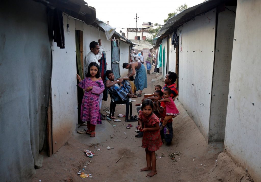 People belonging to Rohingya Muslim community sit outside their makeshift houses on the outskirts of Jammu May 5, 2017. Image: Reuters/Mukesh Gupta