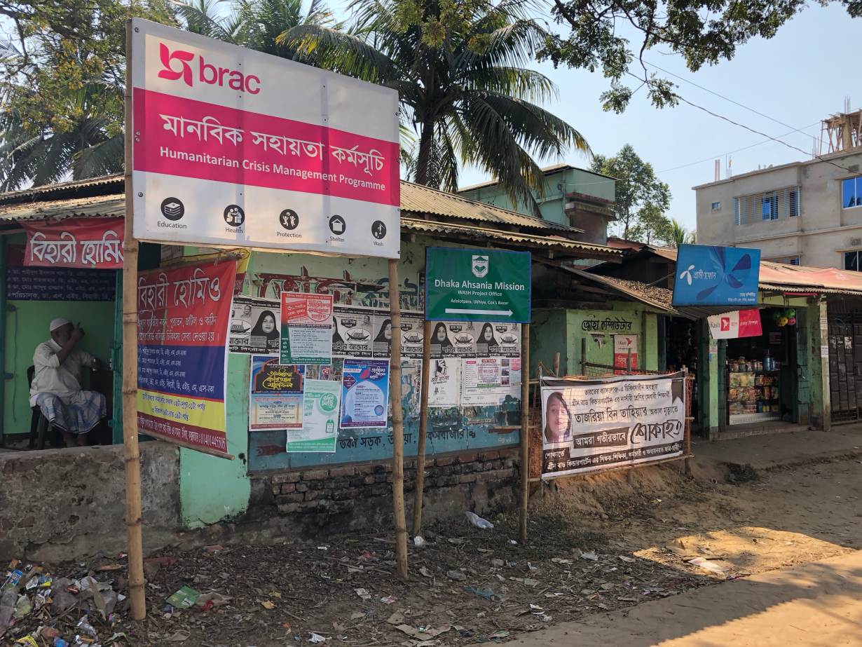 Signs of aid agencies and NGOs are seen by a road to refugee camps in Ukhia, Bangladesh, Jan 29,2019. THOMSON REUTERS FOUNDATION/Belinda Goldsmith