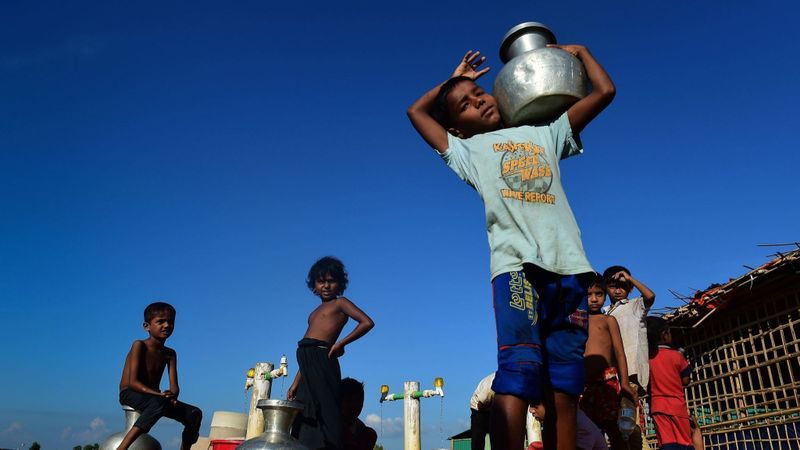 Rohingya refugee children collect drinking water from a tube well at Hakimpara refugee camp in southern Bangladesh. (Munir Uz Zaman / AFP/Getty Images)